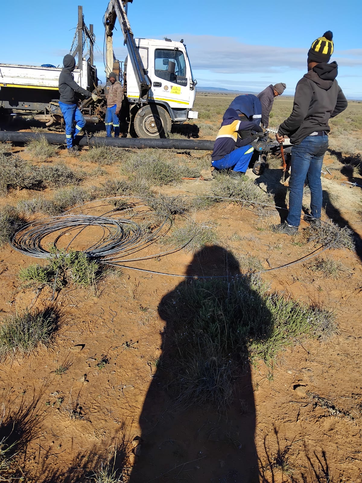Field crew preparing a pole assembly and line components